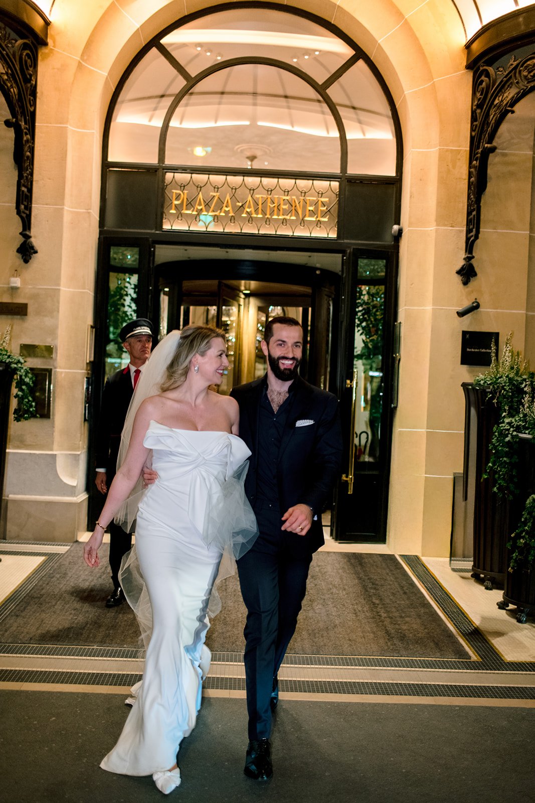Bride and groom stepping onto Avenue Montaigne from Hôtel Plaza Athénée